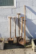 Group of six assorted garden hand tools. Including a rake, fork and spade, etc. All items in this