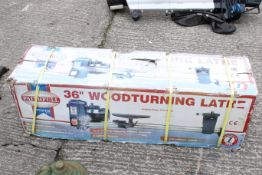 A Faithful Tools 36'' woodturning lathe. In original packaging. Box size L120cm W34cm H38cm.