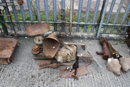 A collection of bygone hand tools and two weighting scales. Including a seed fiddle and a hand
