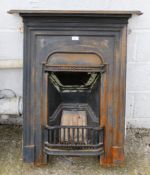 A 20th century cast iron fireplace and brass fender. Having moulded decoration and a mantlepiece,