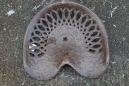 A brown cast iron Victor tractor seat. W41cm D36cm. All items in this auction are sold as seen, We