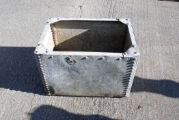 A galvanized metal riveted water tank. H44cm x W64cm x D44cm.