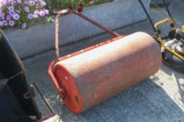 Red pull along lawn roller.