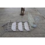Three metal garden items. To include two three-teired pot shelves, and a hanging basket. Two in
