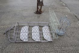 Three metal garden items. To include two three-teired pot shelves, and a hanging basket. Two in