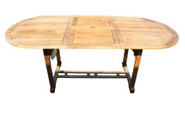 An extendable teak garden table. With rounded ends and umbrella hole. L150cm (L200cm extended) W90cm