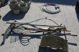 A group of assorted garden hand tools. Including a rack and sythe, etc. All items in this auction