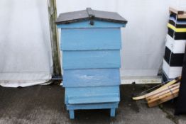 A blue painted wooden beehive. Without beehive frames. H104cm W560cm D60cm. All items in this