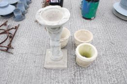Three reconstituted stone plant pots and a bird bath. The bird bath having a Churub figure holding a