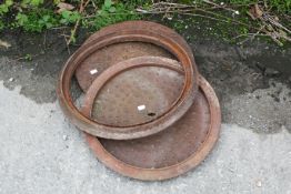 Two cast iron inspection chamber manhole drain covers and surrounds. One marked Osma Drain to the