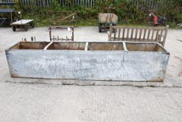 A large galvanised metal trough. Base heavily coroded with numerous small holes; not water-tight.
