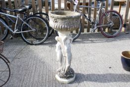 Reconstituted stone garden planter on stand. Having 'three graces' plinth. H87cm diameter 37cm All