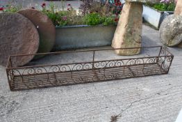 A large metalwork window box planter.