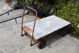 A metal and wooden four-wheel Geest trolley. With two axles, the front attached to handles for