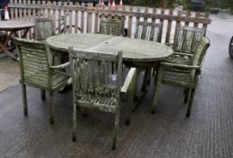 A teak garden table and seven matched carver chairs (4 & 3). Table L180cm W120cm H75cm. Chairs