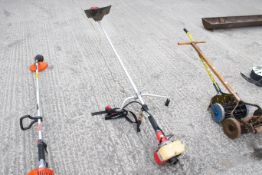 A Mitsubishi TU26 petrol-powered garden strimmer. L160cm. All items in this auction are sold as