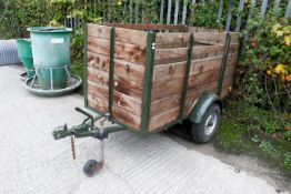A small single-axle Bradley Double Flock livestock trailer. With wooden slatted frame and metal