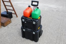 A Dewalt stacking trolley tool box with two petrol cans. All items in this auction are sold as seen,