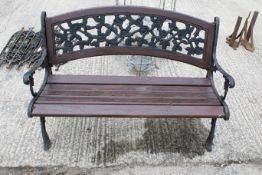A metal and wood two-seater garden bench. With black painted metal bench ends and floral design to