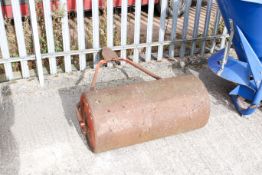 A orange pull along lawn roller. W90cm All items in this auction are sold as seen, We are unable