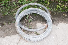 Two coils of galvanised line wire. Length unknown. Coil C60cm. All items in this auction are sold as