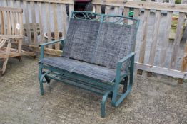A modern two-seater glider bench. Green paint with grey weatherproof upholstery. W108cm H95cm D70cm.