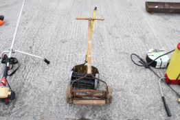 A push-along lawn mower and lawn spiker. The mower marked 'SIF British Manufacture' and the