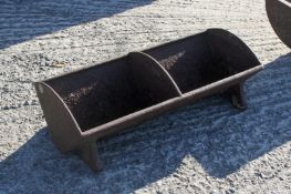 A small metal feed trough. H20cm x W60cm x D26cm