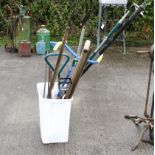 A collection of garden tools. To include spades, rakes, a shooting stick, and more. Max height