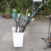 A collection of garden tools. To include spades, rakes, a shooting stick, and more. Max height