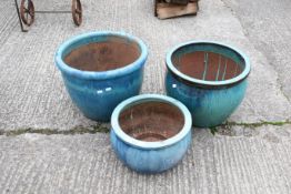 Three large blue glazed plant pots. The largest H40cm C50cm. All items in this auction are sold as