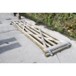A pair of large wooden gates. Each with galvanised steel hinge and latch hardware. W365cm H120cm.