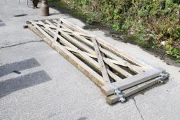 A pair of large wooden gates. Each with galvanised steel hinge and latch hardware. W365cm H120cm.