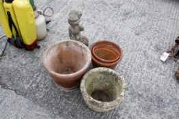 Four garden pots and a statue of a Churub. Three pots being terracotta and the other two items