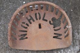 A cast iron Nicholson tractor seat. Marked 'Nicholson Registered Trade Mark' to the seat. W42cm