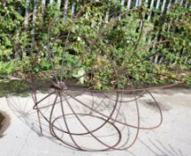 A large wrought iron hanging garden seat frame. Diameter 154cm All items in this auction are sold as