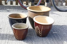 A group of four assorted glazed garden plant pots. Max. H34cm diameter 39cm All items in this