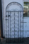 A wrought iron scroll side gate. H191cm x W82cm All items in this auction are sold as seen, We are
