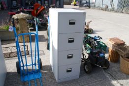 A grey metal four drawer filing cabinet with key. H132cm All items in this auction are sold as seen,