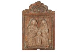 A carved wood religious panel.