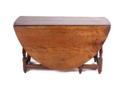 A late 18th century oak gateleg dining table with oval top. Having a drawer to one end.