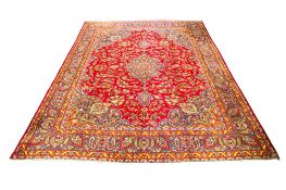 A large Persian style woollen rug.