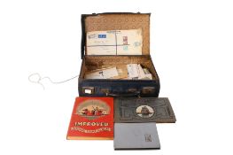 A collection of assorted world stamps, in a small suitcase.