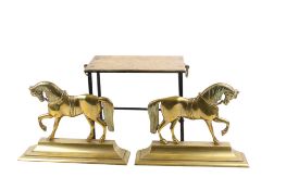 A pair of early 20th century brass chimney ornaments and a trivet stand.