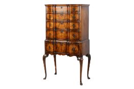 A Queen Anne style walnut veneered inverted bowfront chest on stand.