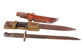 Two WWII bayonets and a hunting knife.