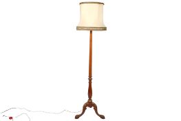An early 20th century wooden standard lamp.