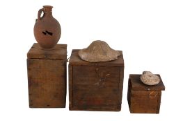 A collection of ancient Egyptian historical artifacts contained within wooden military boxes.