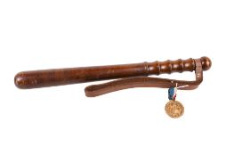 An early 20th century truncheon and a WWI Birmingham Peace Medal.