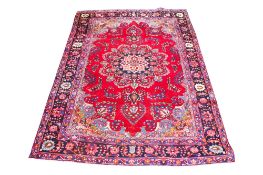 A vintage Persian woollen rug.